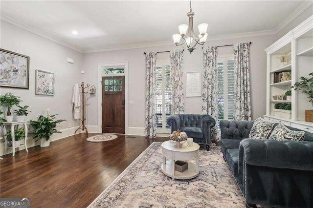 living room featuring hardwood / wood-style floors, a notable chandelier, and crown molding