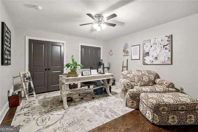 interior space with ceiling fan and hardwood / wood-style floors