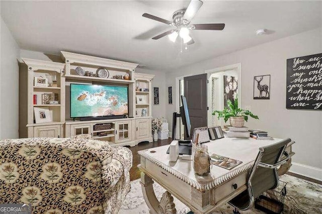 interior space with ceiling fan and wood-type flooring