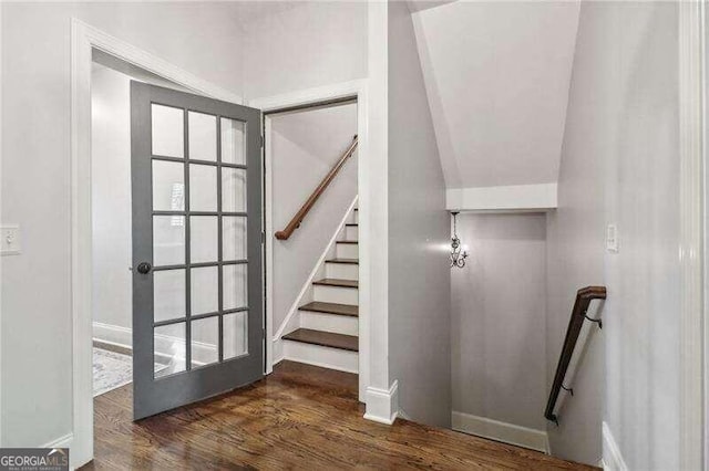 staircase with hardwood / wood-style floors