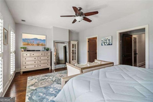 bedroom with ceiling fan, a closet, and dark wood-type flooring