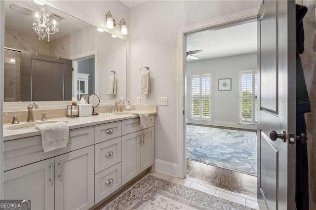 bathroom with vanity and a notable chandelier