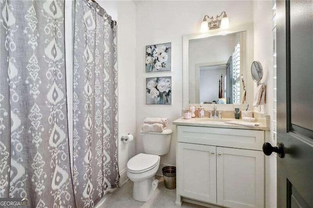 bathroom featuring curtained shower, vanity, and toilet