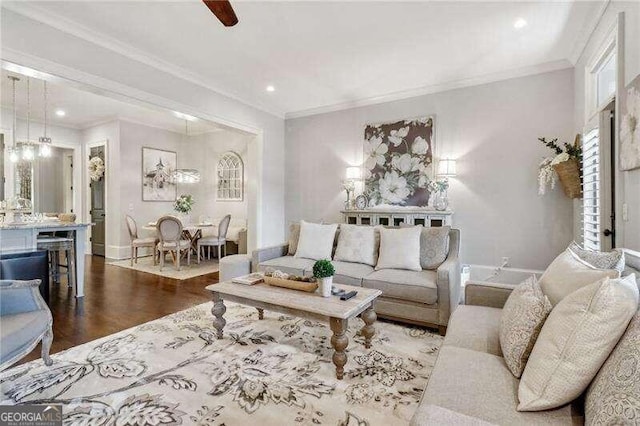 living room with wood-type flooring and ornamental molding