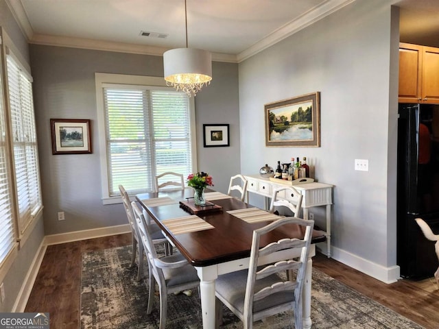 dining space with ornamental molding, dark wood-style flooring, and a wealth of natural light