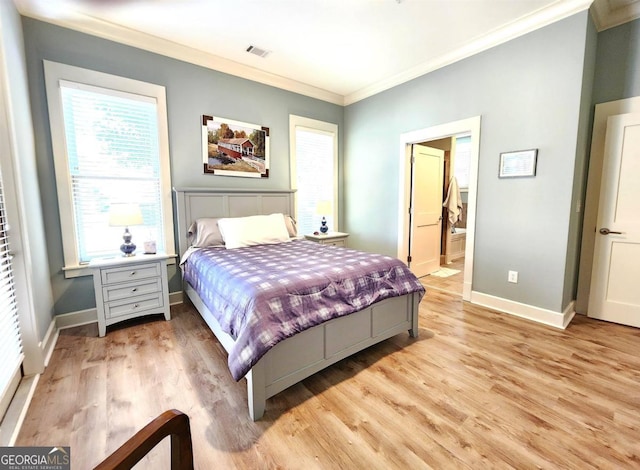 bedroom featuring ensuite bath, ornamental molding, and light wood-type flooring