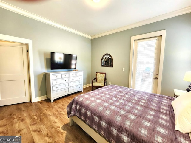 bedroom featuring light hardwood / wood-style flooring and crown molding