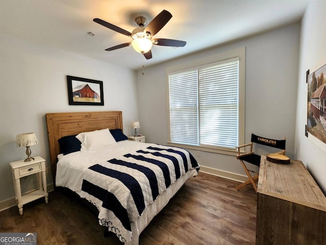 bedroom with dark hardwood / wood-style flooring and ceiling fan