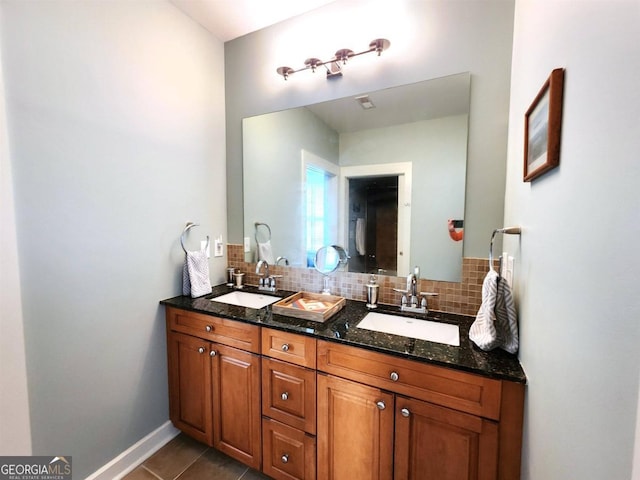 full bath with double vanity, tile patterned floors, decorative backsplash, and a sink