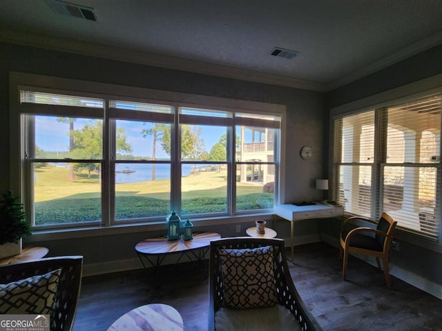 sunroom / solarium featuring a water view