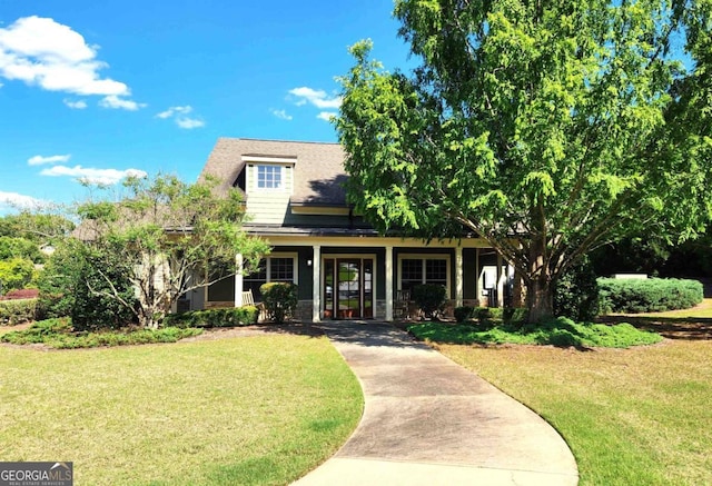 view of front of property featuring covered porch and a front yard