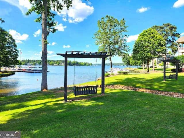 view of home's community featuring a water view and a lawn