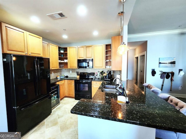 kitchen featuring decorative backsplash, kitchen peninsula, sink, black appliances, and pendant lighting