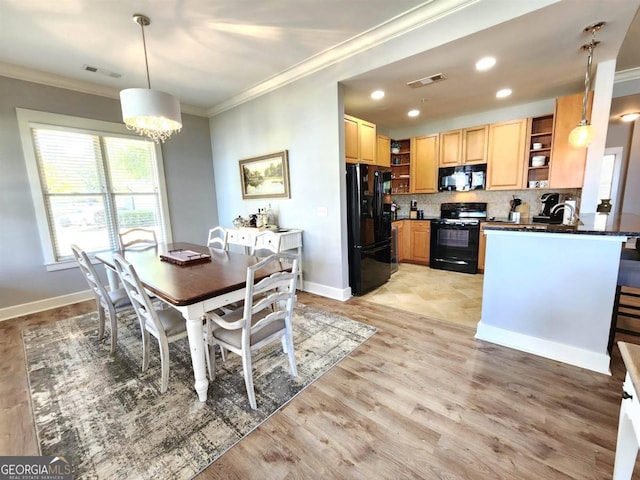 dining room featuring crown molding, sink, and light wood-type flooring