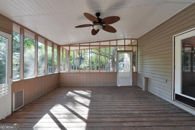 unfurnished sunroom with ceiling fan and vaulted ceiling