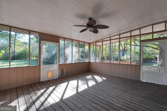 unfurnished sunroom with ceiling fan, a healthy amount of sunlight, vaulted ceiling, and wooden ceiling