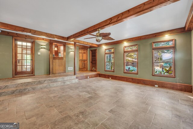 empty room with beam ceiling and ceiling fan