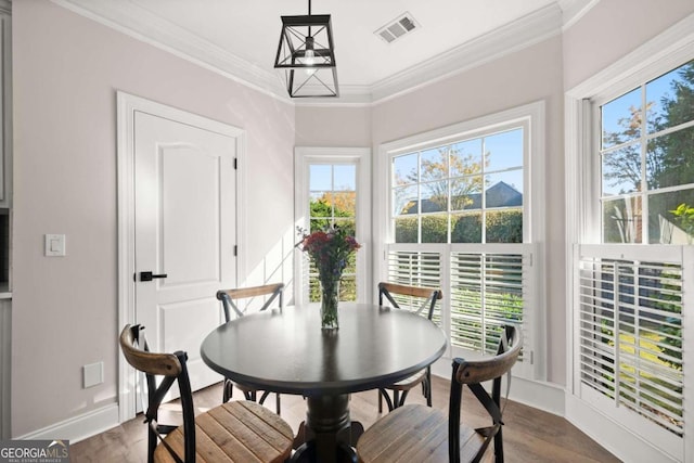 dining room featuring ornamental molding and hardwood / wood-style flooring