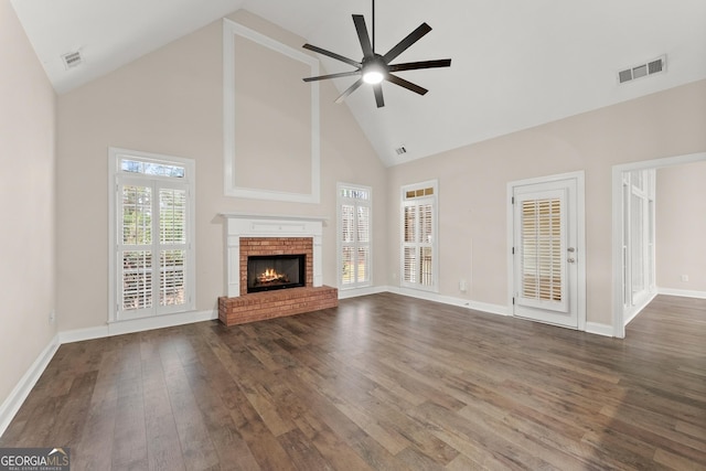 unfurnished living room featuring ceiling fan, a fireplace, high vaulted ceiling, and dark wood-type flooring