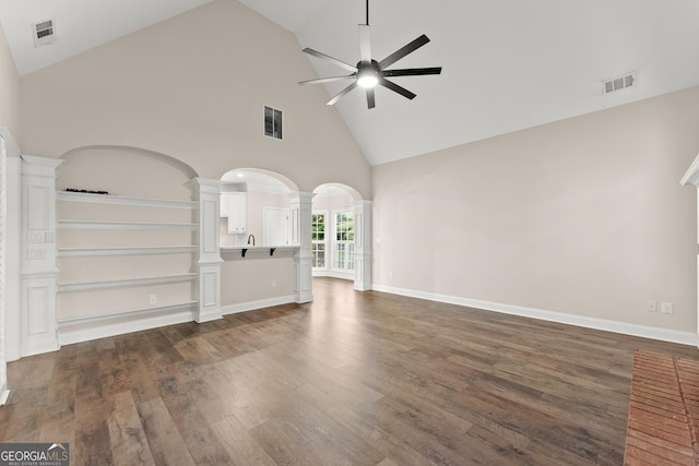 unfurnished living room featuring high vaulted ceiling, ceiling fan, and dark wood-type flooring