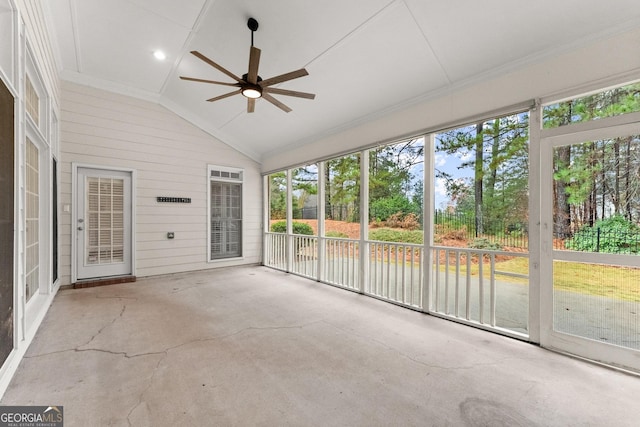 sunroom / solarium with ceiling fan and vaulted ceiling