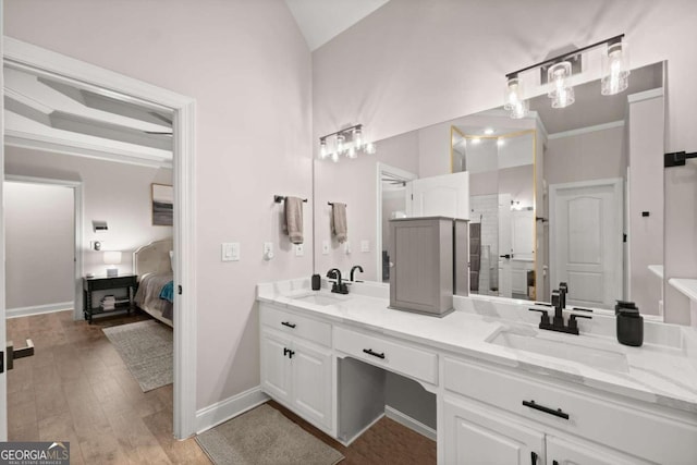 bathroom with a shower, crown molding, vanity, and wood-type flooring