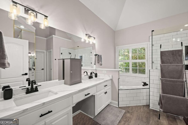 bathroom with vanity, wood-type flooring, lofted ceiling, and independent shower and bath