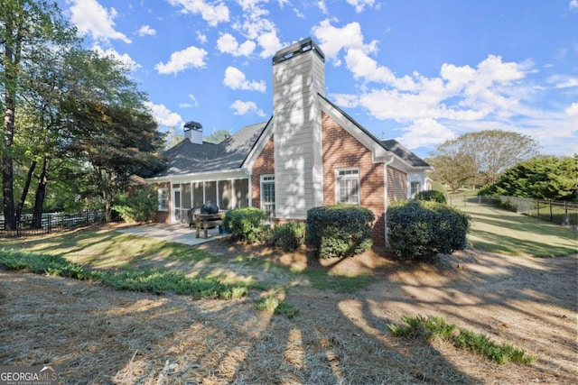 exterior space with a sunroom and a patio