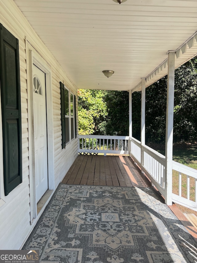 wooden terrace with a porch