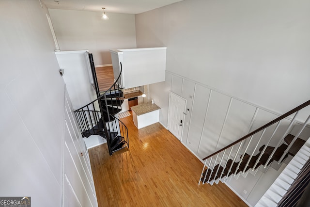 stairway with hardwood / wood-style floors