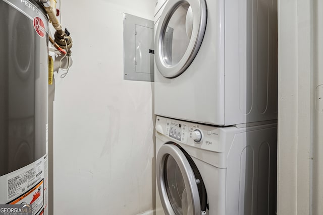 laundry area with gas water heater and stacked washing maching and dryer