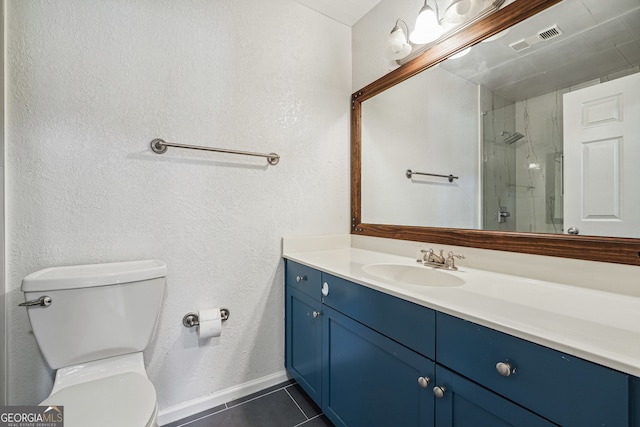 bathroom featuring vanity, toilet, tile patterned floors, and an enclosed shower