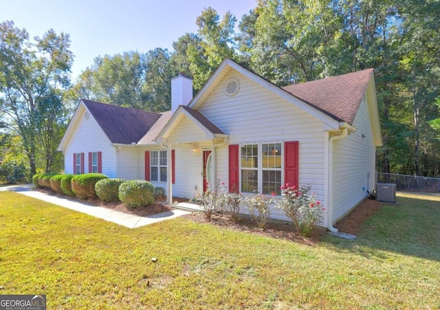 view of front facade with a front lawn and central AC unit