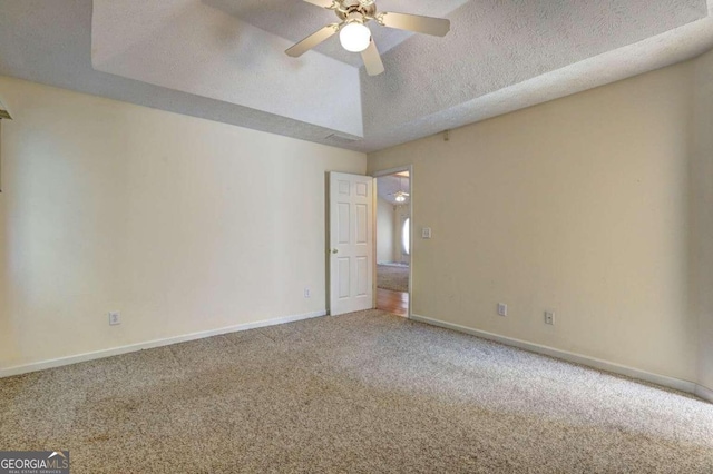 carpeted spare room with ceiling fan and a textured ceiling