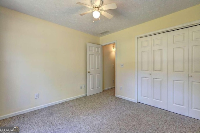 unfurnished bedroom with light carpet, a closet, a textured ceiling, and ceiling fan