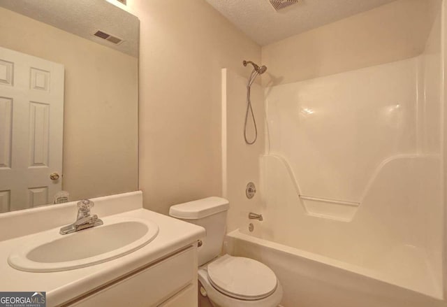 full bathroom featuring toilet, a textured ceiling, vanity, and shower / bathtub combination