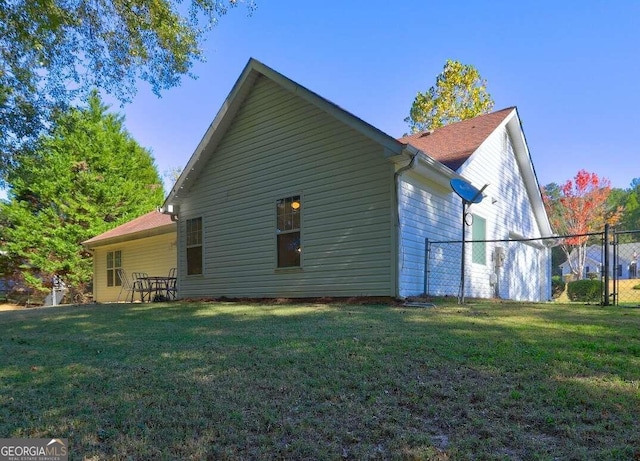 back of property featuring a yard