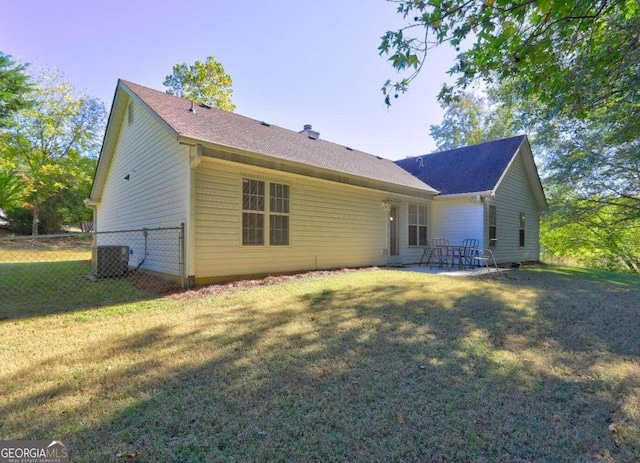 back of property featuring a patio area, central AC, and a lawn