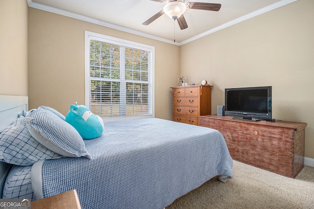 carpeted bedroom featuring ceiling fan and crown molding