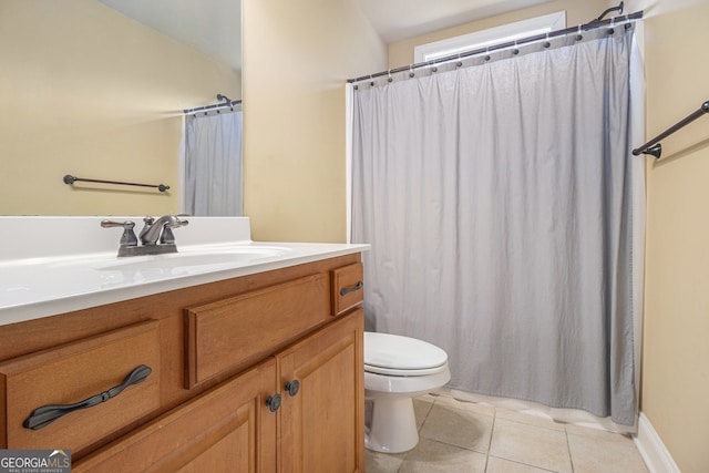 bathroom featuring vanity, curtained shower, toilet, and tile patterned floors