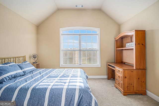 bedroom featuring lofted ceiling and light colored carpet