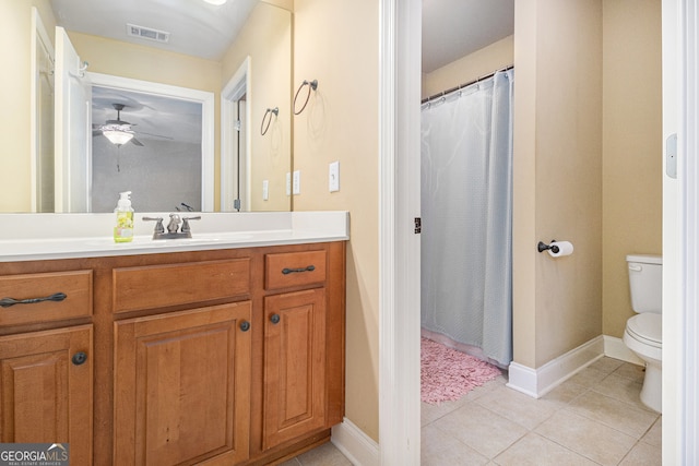 bathroom featuring vanity, toilet, tile patterned flooring, and ceiling fan