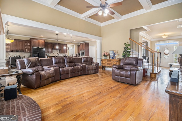 living room with crown molding, light hardwood / wood-style flooring, coffered ceiling, and ceiling fan