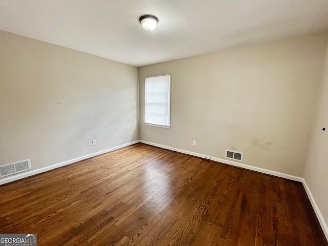 empty room with wood-type flooring