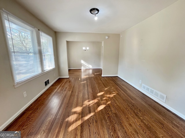 interior space with a notable chandelier and dark hardwood / wood-style floors