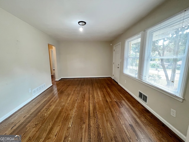 spare room with dark hardwood / wood-style floors