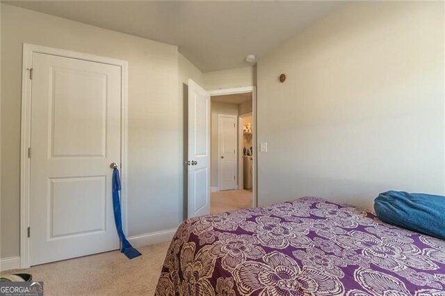 bedroom featuring light colored carpet