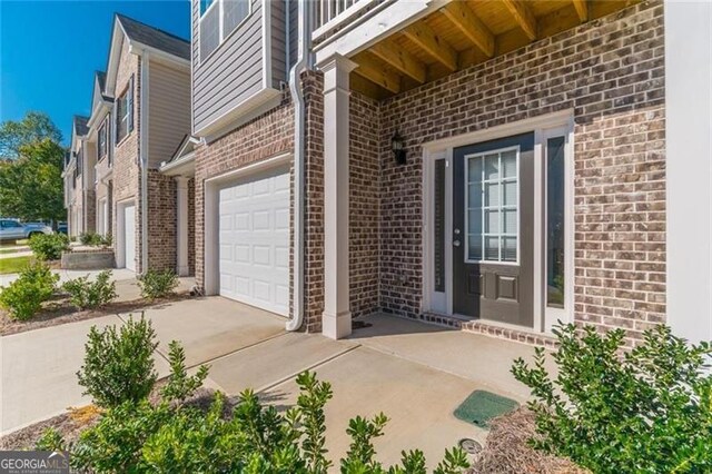 view of exterior entry with a garage