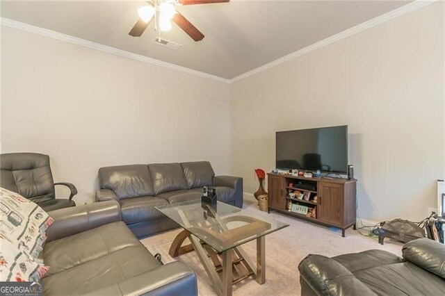 living room featuring ornamental molding, light colored carpet, and ceiling fan