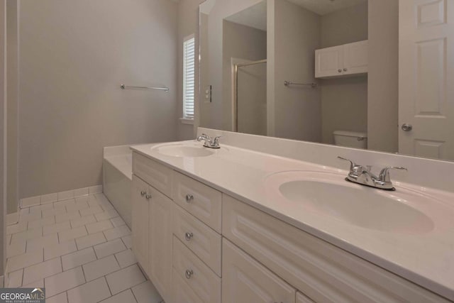 bathroom featuring toilet, walk in shower, vanity, and tile patterned flooring